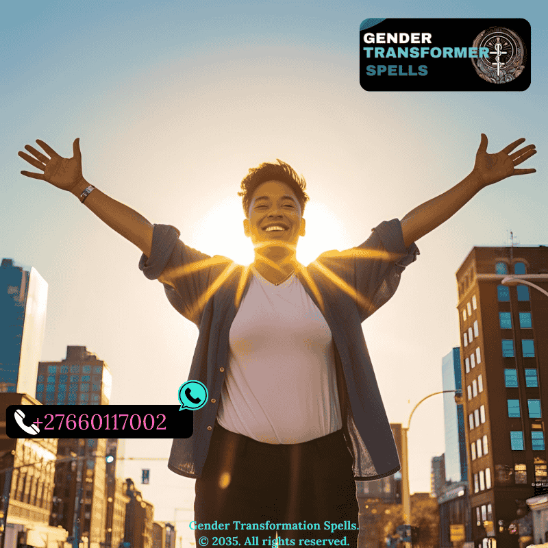 Trans individual standing empowered under sunlight with open arms.